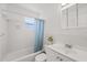 Bright bathroom featuring a shower-tub combo and a vanity with storage space at 5106 Blue Heron Dr, New Port Richey, FL 34652