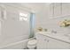 Clean white bathroom features a shower-tub combo and a classic white vanity at 5106 Blue Heron Dr, New Port Richey, FL 34652