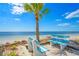 Benches on the beach with ocean views and palm trees, perfect for relaxation at 5106 Blue Heron Dr, New Port Richey, FL 34652