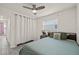 Simple bedroom with a bed, nightstand, a window with blinds, and a ceiling fan at 5106 Blue Heron Dr, New Port Richey, FL 34652