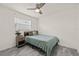 Cozy bedroom with a bed, nightstand, wood-look flooring, and a ceiling fan at 5106 Blue Heron Dr, New Port Richey, FL 34652