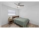 Bright bedroom featuring a ceiling fan and wood-look tile flooring at 5106 Blue Heron Dr, New Port Richey, FL 34652