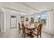 Dining room boasts an expansive window view, tile floor, and light wood dining table at 5106 Blue Heron Dr, New Port Richey, FL 34652