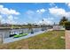 Waterfront dock with boat lift and kayak on a sunny day at 5106 Blue Heron Dr, New Port Richey, FL 34652