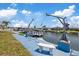 Waterfront dock with a boat lift and bench overlooking canal at 5106 Blue Heron Dr, New Port Richey, FL 34652