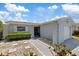 Inviting one-story home with tidy landscaping, and a paved walkway leading to the front door at 5106 Blue Heron Dr, New Port Richey, FL 34652