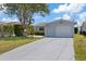 Charming single-story home featuring a well-manicured lawn, front garden, and a concrete driveway at 5106 Blue Heron Dr, New Port Richey, FL 34652