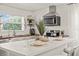Modern kitchen features stainless steel appliances, an island with seating, and new backsplash at 5106 Blue Heron Dr, New Port Richey, FL 34652