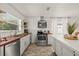 Bright kitchen features stainless steel appliances, wood countertops, and floating shelves at 5106 Blue Heron Dr, New Port Richey, FL 34652
