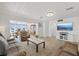 Open living room showcasing neutral decor and tile floors flowing into the dining area at 5106 Blue Heron Dr, New Port Richey, FL 34652
