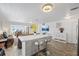 Open-concept living space with a kitchen island, comfortable seating, and lots of natural light at 5106 Blue Heron Dr, New Port Richey, FL 34652