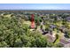 Stunning aerial view of the home with lush landscaping, mature trees and golf course views at 5198 Legend Hills Ln, Brooksville, FL 34609