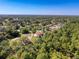 Aerial view of the home with pool, golf course, and lush green trees at 5198 Legend Hills Ln, Brooksville, FL 34609