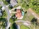 An overhead view of a home featuring a pool surrounded by lush greenery and mature trees at 5198 Legend Hills Ln, Brooksville, FL 34609