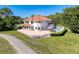 An aerial shot showcases a backyard with a pool, complemented by a lush green lawn and trees at 5198 Legend Hills Ln, Brooksville, FL 34609