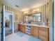 This bright bathroom features a double vanity and a view into the Primary bedroom at 5198 Legend Hills Ln, Brooksville, FL 34609