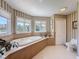 This bright bathroom boasts a large soaking tub surrounded by windows at 5198 Legend Hills Ln, Brooksville, FL 34609