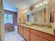 This bright bathroom boasts a double vanity with granite countertops and a soaking tub at 5198 Legend Hills Ln, Brooksville, FL 34609