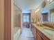 This charming bathroom offers a double vanity with granite countertops and a shower/tub combo at 5198 Legend Hills Ln, Brooksville, FL 34609