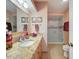 Well-lit bathroom features a granite vanity and walk-in shower with glass door at 5198 Legend Hills Ln, Brooksville, FL 34609