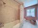 This charming bathroom offers a shower/tub combo and a large window for natural light at 5198 Legend Hills Ln, Brooksville, FL 34609