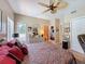 Comfortable bedroom featuring a ceiling fan and closet and bathroom entrances at 5198 Legend Hills Ln, Brooksville, FL 34609