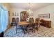 Charming dining room with a large table, chairs, and a carpet creates an inviting atmosphere for meals at 5198 Legend Hills Ln, Brooksville, FL 34609
