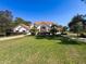 Beautiful single-Gathering home with lush landscaping, palm trees and well-manicured lawn at 5198 Legend Hills Ln, Brooksville, FL 34609