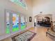 Elegant foyer featuring stained glass double doors, high ceilings, and a view into the dining room at 5198 Legend Hills Ln, Brooksville, FL 34609