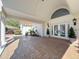 Welcoming front entrance with double doors with decorative glass, and brick paver drive-through portico at 5198 Legend Hills Ln, Brooksville, FL 34609