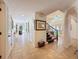 Bright hallway with neutral paint and flooring, chandelier, and lots of access to other rooms at 5198 Legend Hills Ln, Brooksville, FL 34609