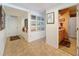 Tiled hallway view of bathroom with framed photos and recessed lighting at 5198 Legend Hills Ln, Brooksville, FL 34609