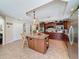 Spacious kitchen with an island, stainless steel appliances, wine rack and dark wood cabinetry at 5198 Legend Hills Ln, Brooksville, FL 34609