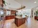 Spacious kitchen with a central island, wooden cabinetry, tiled floor and lots of natural light at 5198 Legend Hills Ln, Brooksville, FL 34609