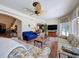 Bright and airy living room with large windows, comfortable couches, tile floors and a ceiling fan at 5198 Legend Hills Ln, Brooksville, FL 34609