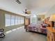 Comfortable main bedroom featuring a large window, carpet and ample space for relaxation at 5198 Legend Hills Ln, Brooksville, FL 34609