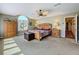 Serene main bedroom with a ceiling fan, large window, and cozy decor for a relaxing retreat at 5198 Legend Hills Ln, Brooksville, FL 34609