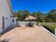 Spacious patio with dining table, lounge chairs, and sunny skies; an ideal outdoor relaxation spot at 5198 Legend Hills Ln, Brooksville, FL 34609