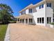 Expansive outdoor patio and beautifully landscaped grounds showcase space for leisure and entertaining guests at 5198 Legend Hills Ln, Brooksville, FL 34609