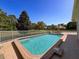 Relaxing pool overlooking manicured lawns and landscaping, complete with lounge area and table for outdoor enjoyment at 5198 Legend Hills Ln, Brooksville, FL 34609