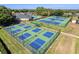 Aerial view of well-maintained community tennis and pickleball courts at 5198 Legend Hills Ln, Brooksville, FL 34609