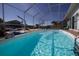 Inviting enclosed swimming pool offers a private oasis with clear blue water and ample space for relaxation and recreation at 5404 Quist Dr, Port Richey, FL 34668
