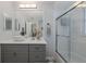 Modern bathroom with sleek vanity, decorative mirror, glass shower and tub, offering style and comfort at 5607 Wellfield Rd, New Port Richey, FL 34655