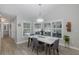 Bright dining room with a modern table, chairs, and large windows with shutter-style blinds at 5607 Wellfield Rd, New Port Richey, FL 34655
