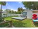 A backyard with lush grass, a cozy deck seating area, and kayaks, ideal for outdoor enjoyment and watersports at 7252 Coventry Ct, Weeki Wachee, FL 34607