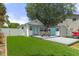 Inviting backyard features a well-manicured lawn, a seating area on the deck, and a storage shed for convenience at 7252 Coventry Ct, Weeki Wachee, FL 34607