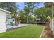 Backyard features a deck with outdoor seating, lush grass, and access to the waterfront, perfect for entertaining at 7252 Coventry Ct, Weeki Wachee, FL 34607