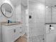 Well-lit modern bathroom featuring stylish tiling, an updated vanity, and a sleek, glass-enclosed shower at 7252 Coventry Ct, Weeki Wachee, FL 34607