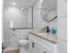 Modern bathroom with a glass-enclosed shower, marble-style tile, and a stylish vanity at 7252 Coventry Ct, Weeki Wachee, FL 34607