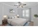 Cozy bedroom featuring a plush bed, ceiling fan, and a bright window with stylish curtains at 7252 Coventry Ct, Weeki Wachee, FL 34607